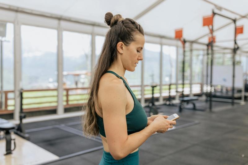 woman with fitness class booking app