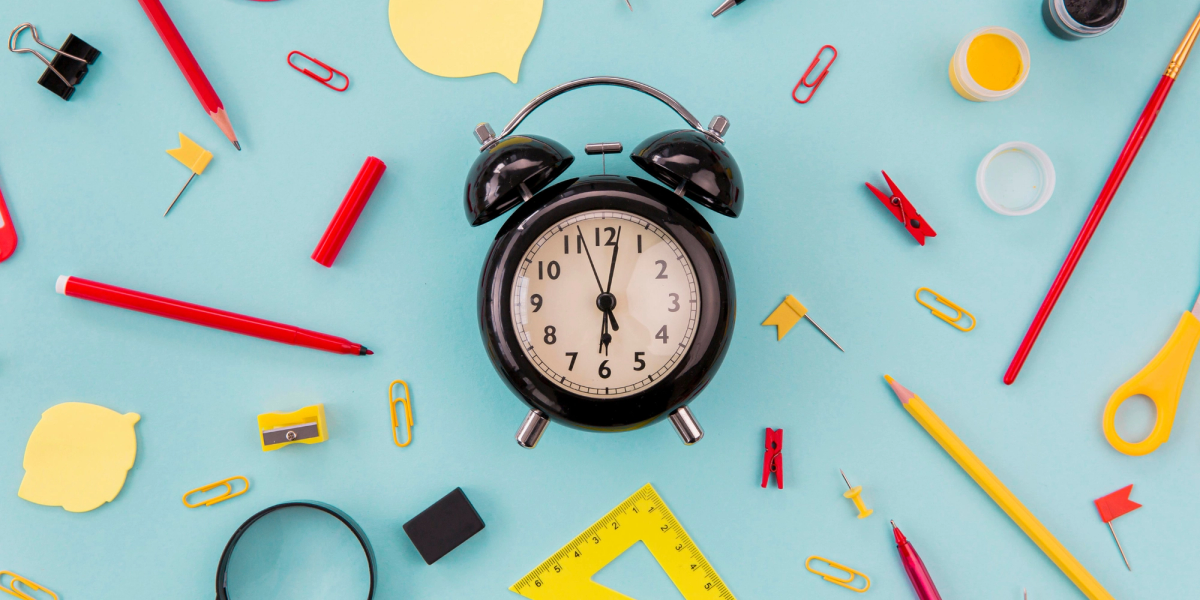 alarm clock, glasses, notebook and pencil—visual for best time management tools to save time